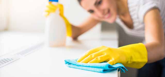 Woman cleaning windowsill